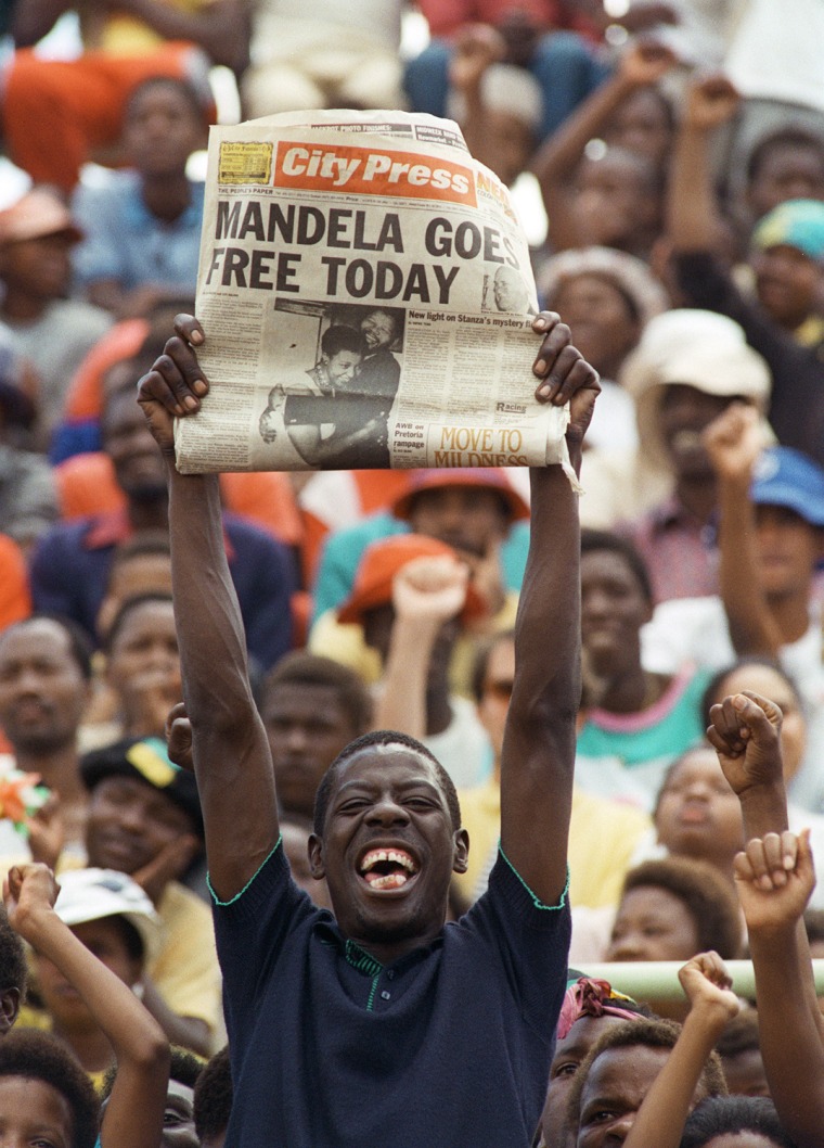 A jubilant Sowetan holds up 11 February