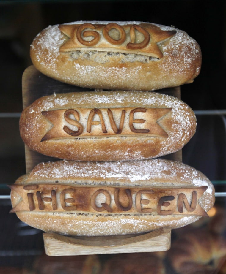 Image: Sourdough bread, decorated with the slogan \"God Save the Queen\" is seen in a bakery window along Elizabeth Street in London