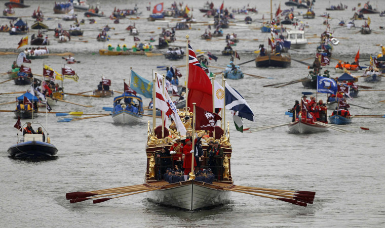 Image: The Gloriana leads the manpowered craft towards Westminster Bridge during Queen Elizabeth's Diamond Jubilee Pageant on the River Thames in London