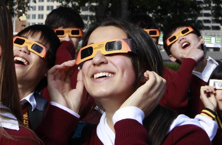 Image: Schoolchildren look at the planet Venus transiting across the sun at Sydney's Observatory