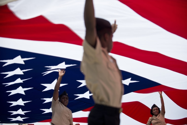 Image: Members of the US Navy's JROTC hold up a