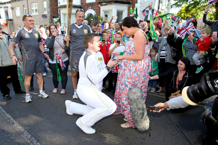 Image: Olympic torch bearer proposes to his girlfriend.