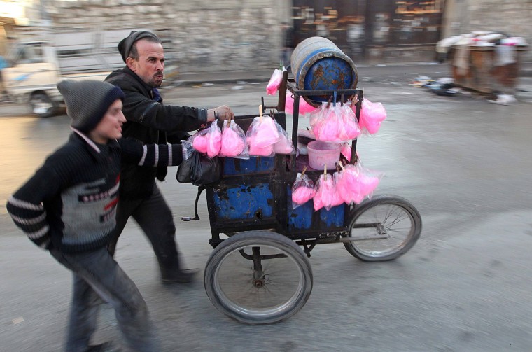 Image: A street vendor sells cotton candy in Aleppo