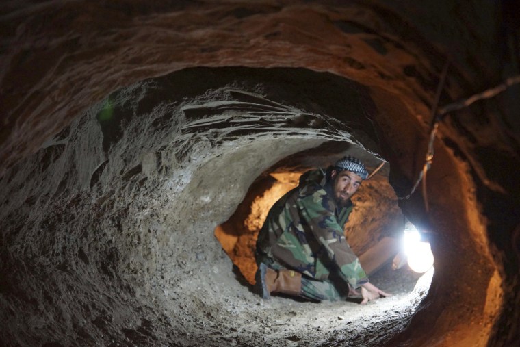 Image: A Free Syrian Army fighter is seen in a tunnel in Deir al-Zor