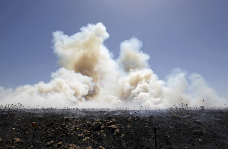 Image: Smoke from brush fires is seen near the Quneitra border crossing between Israel and Syria