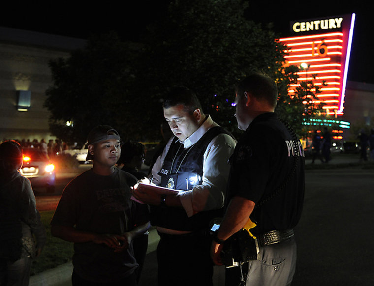 Image: An Aurora Police Department detective took a witness statement following a shooting Friday morning. Aurora Police responded to the Century 16 movie theatre early Friday morning, July 20, 2012.