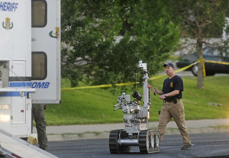 Image: The Aurora bomb squad robot is deployed to search a suspect's car after shooting in Aurora, Colorado