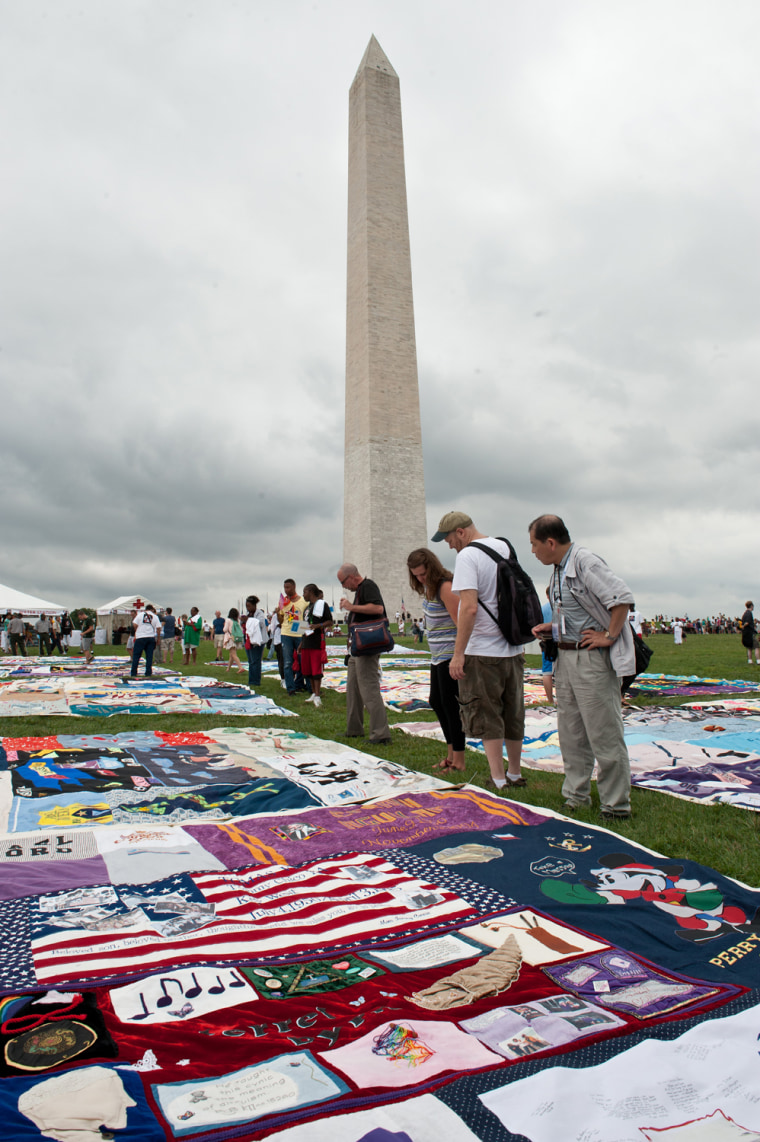 Image: People look at quilts in memory of AIDS