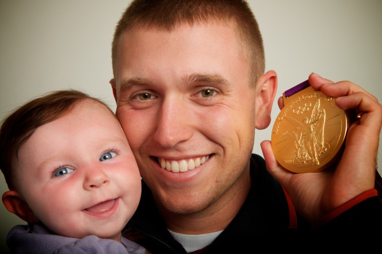 Photo Â© 2012 Neil Leifer -- USA skeet shooting gold medalist Vincent Hancock and his 5-month old daughter Brenlyn pose for a portrait by Neil Leifer during the 2012 Olympics in London, UK on August 1, 2012.