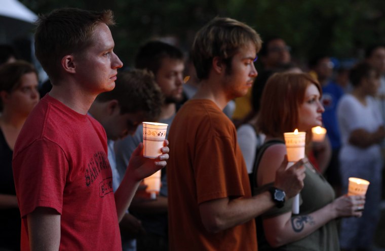 Image: People gather at a candle light vigil at Cathedral Square in downtown Milwaukee, Wisconsin