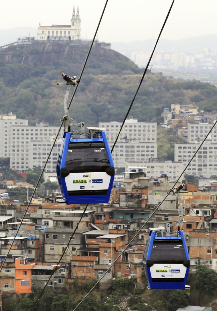 Image: Cable cars are seen in front of the Penha church after Brazil's President Dilma Rousseff opened the new transportation system in Rio de Janeiro