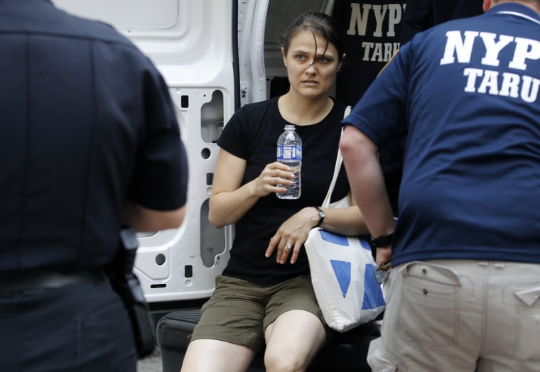 Image: A woman identified as a victim is treated at the scene of a shooting near the Empire State Building in New York