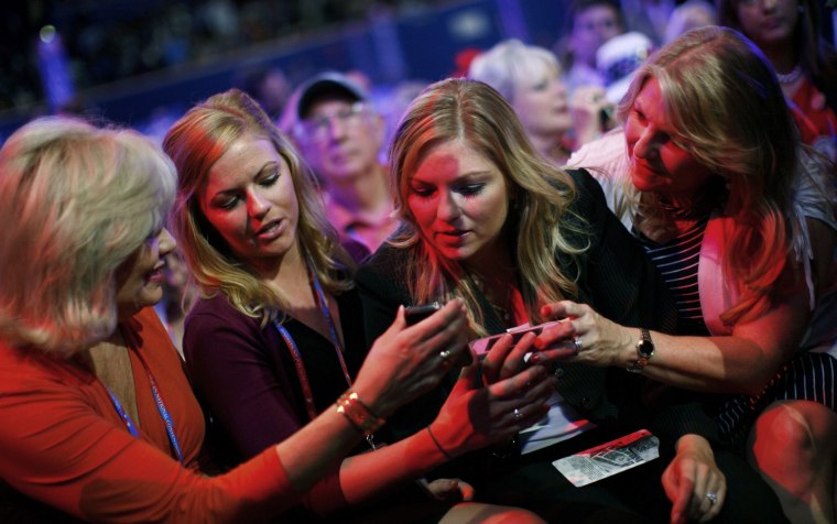 Image: Members of the family of Virginia Governor Bob McDonnell look at their mobile phones after the speech by Senator John McCain during the third day of the Republican National Convention in Tampa