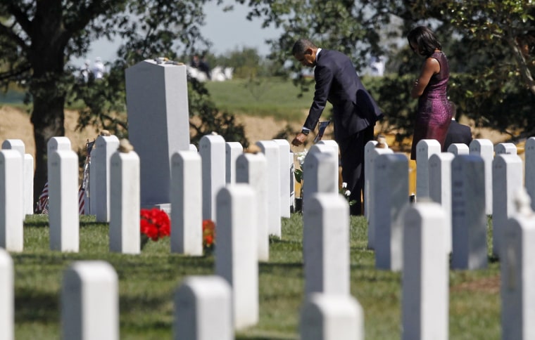 Image: U.S. President Barack Obama and first lady Michelle Obama are pictured during their visit to Arlington National Cemetery on the 11th anniversary of the 9/11 attacks near Washington