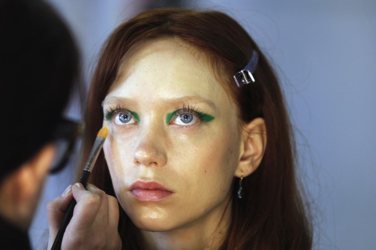Image: A model has her makeup done backstage before a showing of the Marimekko Spring/Summer 2013 collection during New York Fashion Week