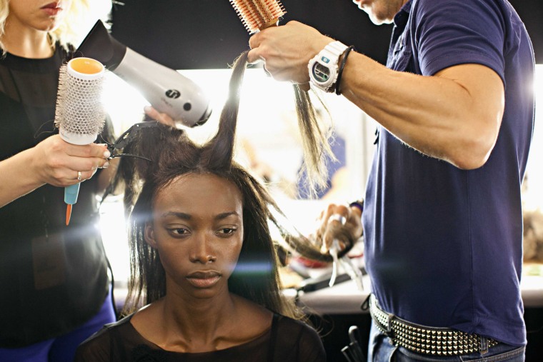 Image: A model has her hair done backstage before the African Icons show, during New York Fashion Week
