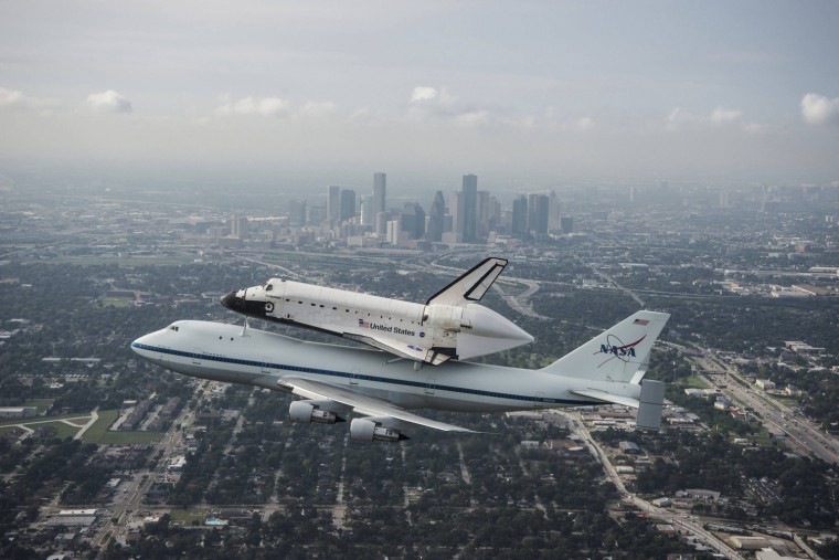 Image: Handout of the space shuttle Endeavour, atop NASA's Shuttle Carrier Aircraft at it flies over Houston