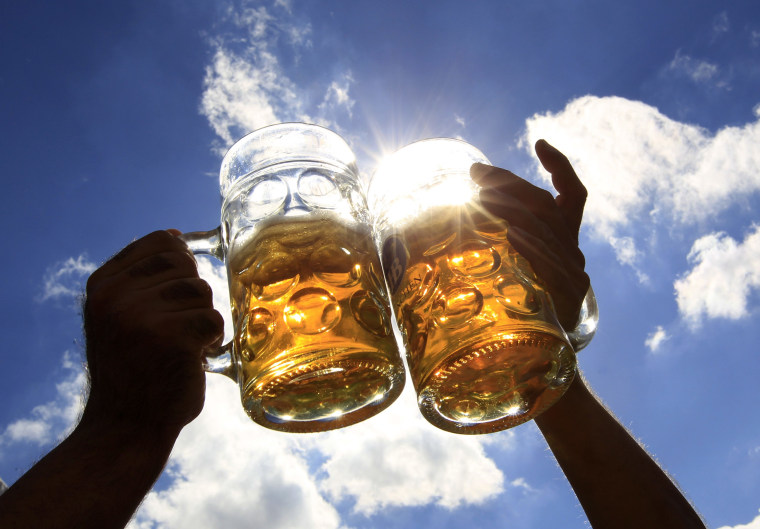 Image: Revellers salute with beer during Oktoberfest in Munich