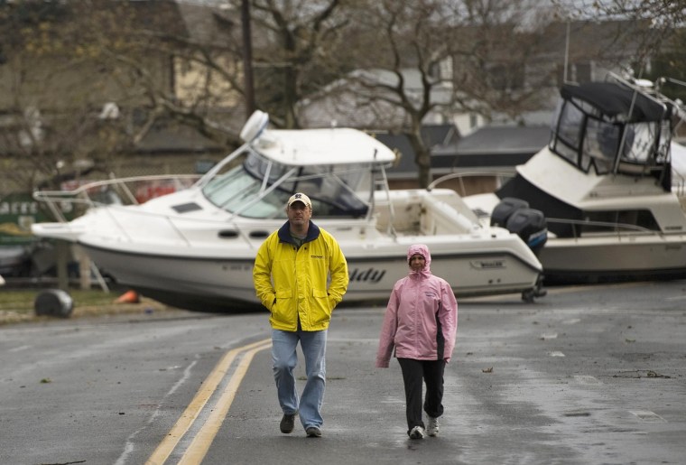 Image: Residents walk along Broadway Avenue as they inspect damage from Hurricane Sandy in Point Pleasant Beach