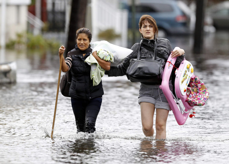 Image: Residents make their way through flood waters brought on by Hurricane Sandy in Little Ferry