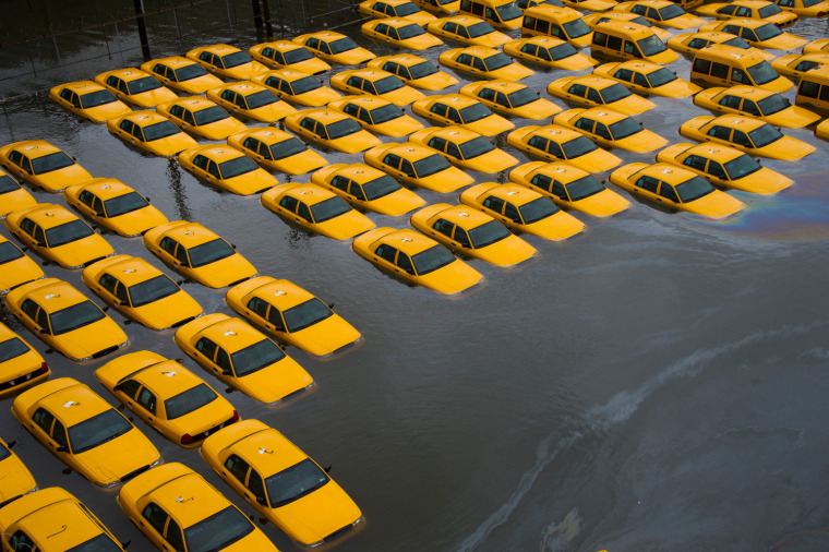 Image: A parking lot full of yellow cabs is flooded as a result of superstorm Sandy on Tuesday, Oct. 30, 2012 in Hoboken, NJ.