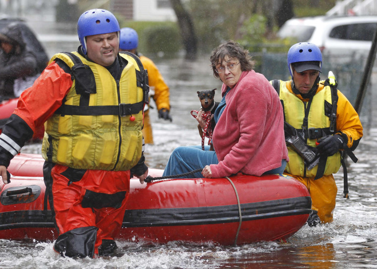 Image: Emergency personnel rescue a resident from flood waters brought on by Hurricane Sandy in Little Ferry