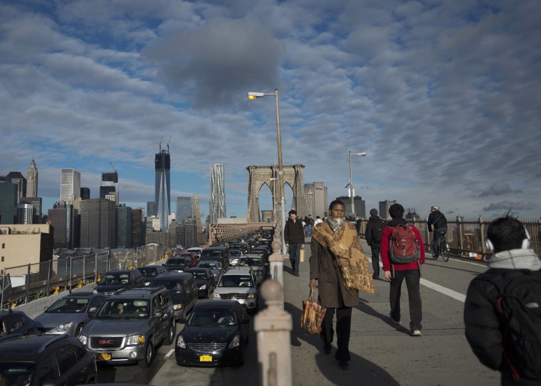 Image: Commuters make their way across the Brooklyn Bridge in New York