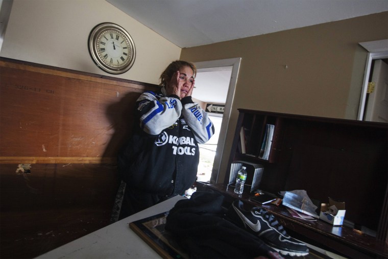 Image: Renter Donna McBride reacts to seeing the damage done to her home by the storm surge of Hurricane Sandy in Lindenhurst, New York
