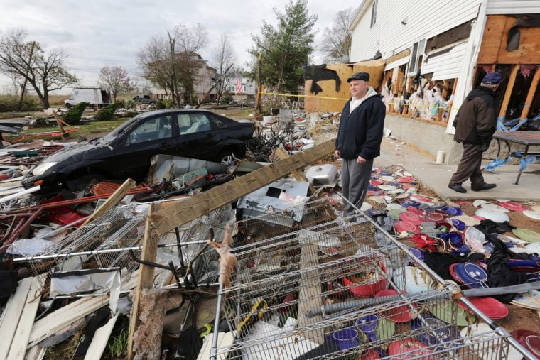 Image: John Dellorusso looks at Hurricane Sandy debris on Staten Island