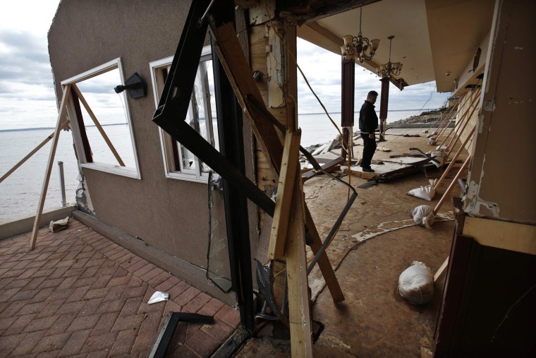 Image: Ben Mancuso, owner of Puglia By The Sea restaurant stands amid the remains of the building that was destroyed by Hurricane Sandy on the south shore of the Staten Island section of New York City