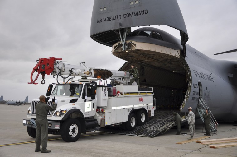 Image: Utility vehicles and crews from California are off-loaded at Stewart Air National Guard Base in Newburgh in this handout photo