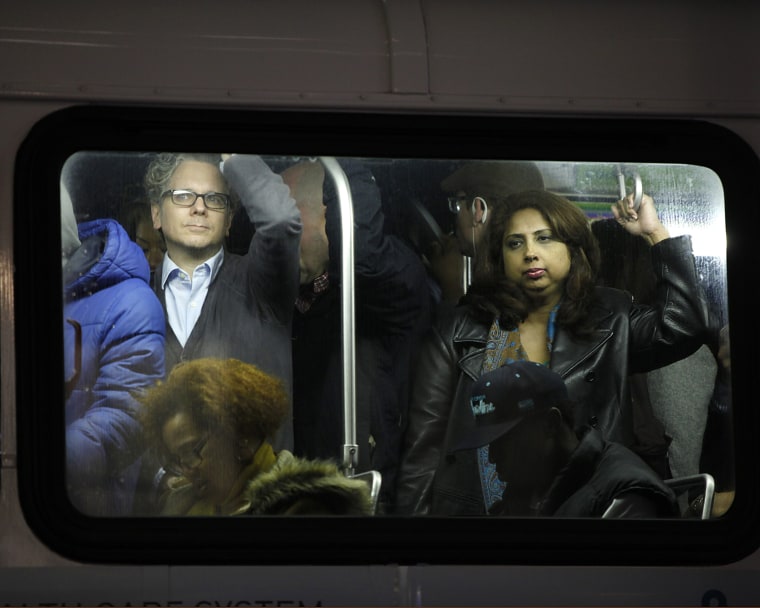 Image: People travel in a bus from Manhattan back to the Brooklyn borough in the aftermath of Hurricane Sandy in New York