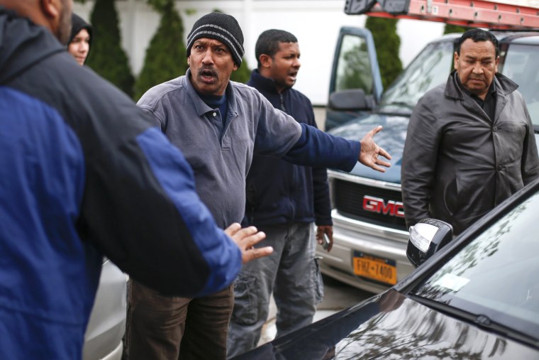 Image: A man fights for his place in line while waiting to get fuel at a gas station in the New York City borough of Queens
