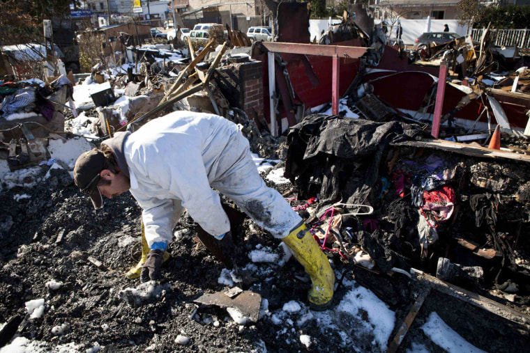 Image: Sylvester searches through remains of his house which was flooded and then burned to the ground during Hurricane Sandy for corpses of his five cats in Midland Beach neighborhood in Staten Island