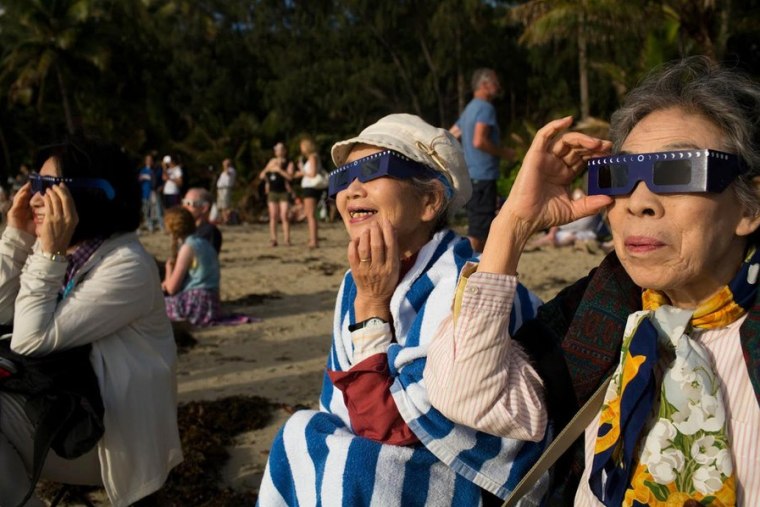 John Brecher / NBC News

At right, Namiko Aoki, 84, from Tokyo, Japan, and companions Keiko Nakamura and Kisako Takahara. watch the moon eclipse the sun from Four Mile Beach in Port Douglas, Australia on Wednesday Nov. 14, 2012.