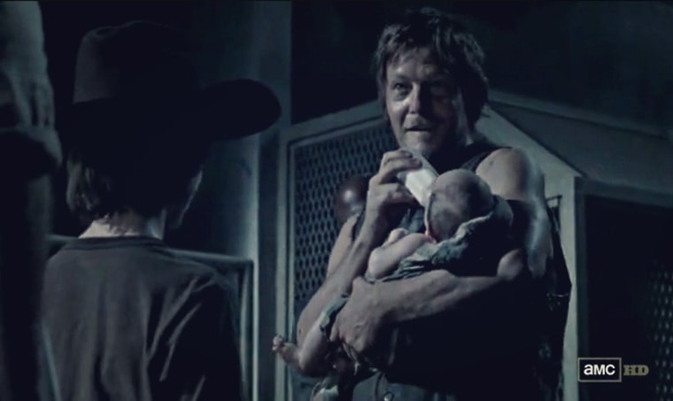 Daryl (Norman Reedus) holds baby Judy on episode five of season three.