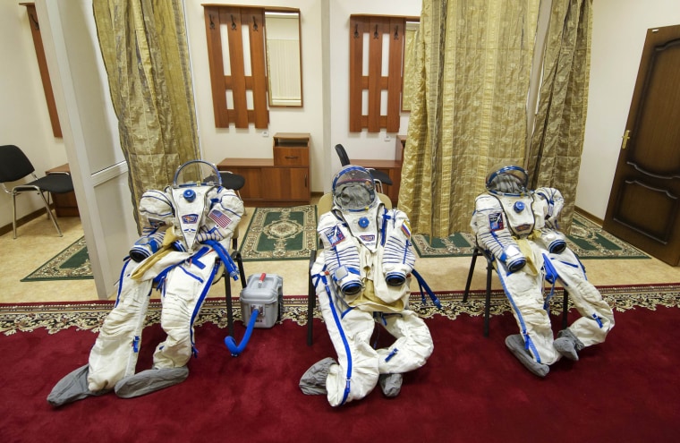Image: Spacesuits are seen laid out for U.S. astronaut Marshburn, Canadian astronaut Hadfield and Russian cosmonaut Romanenko before an exam at Star City outside Moscow