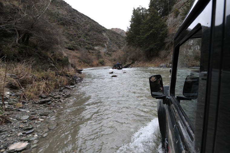 A 4x4 vehicle travels through Bush Creek