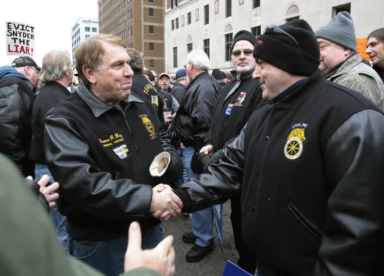 Image: Hoffa General President of the Teamsters Union greets anti right-to-work protesters outside of Michigan's state capitol building in Lansing