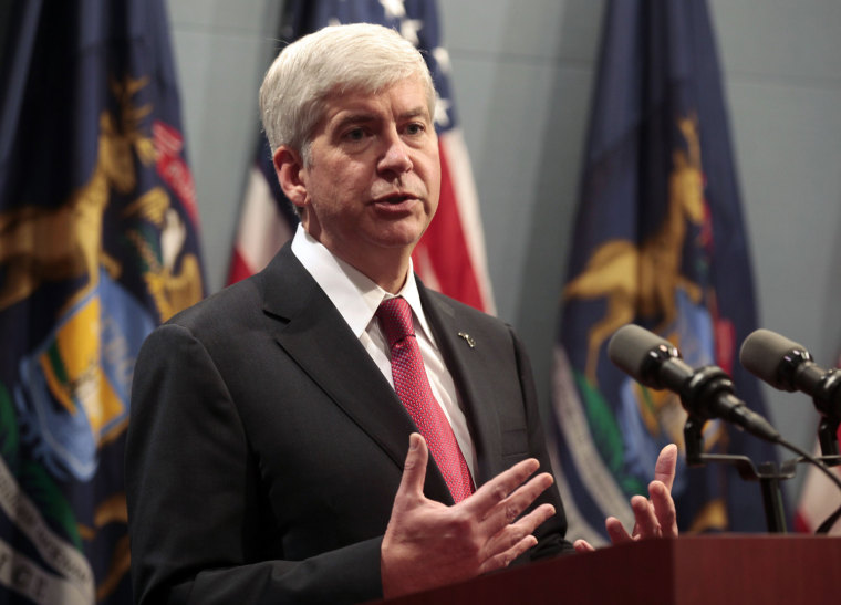 Image: Michigan Governor Rick Snyder holds a news conference to talk about why he signed into law, earlier in the day, right-to-work laws in Lansing, Michigan