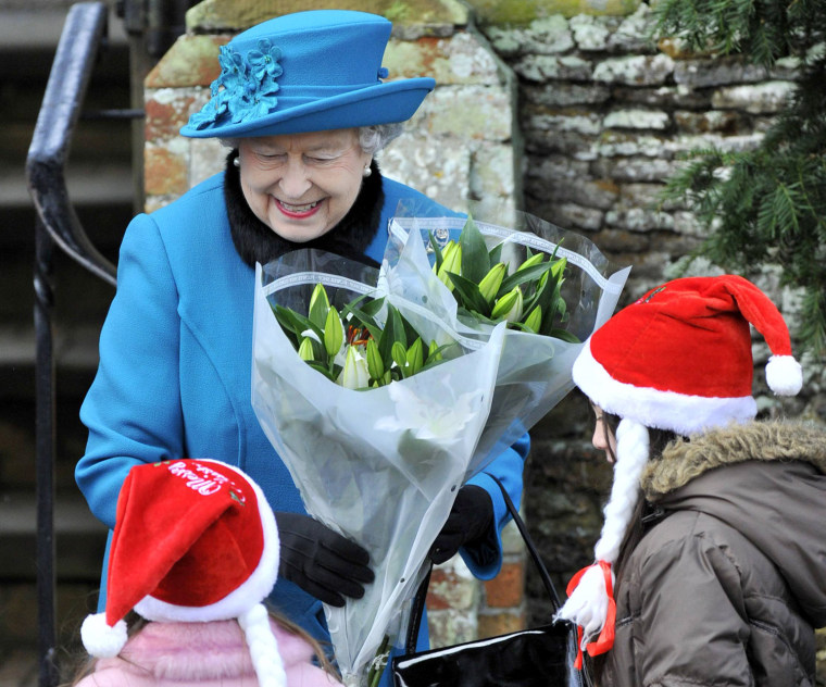 Image: Britain's Queen Elizabeth receives flowers outside of St. Mary's church after attending the annual Christmas service on the Royal Estate at Sandringham in Norfolk, eastern England