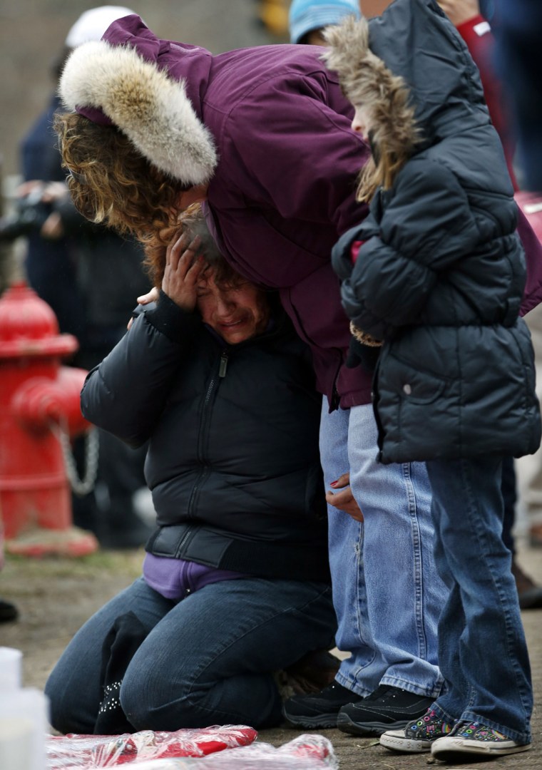 Image: Woman cries at a makeshift memorial near the Sandy Hook Elementary School for the victims of a school shooting in Newtown, Connecticut