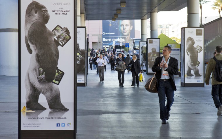 Image: Man walks by advertisement for Corning Gorilla Glass 3 outside Las Vegas Convention Center on first day of Consumer Electronics Show in Las Vegas
