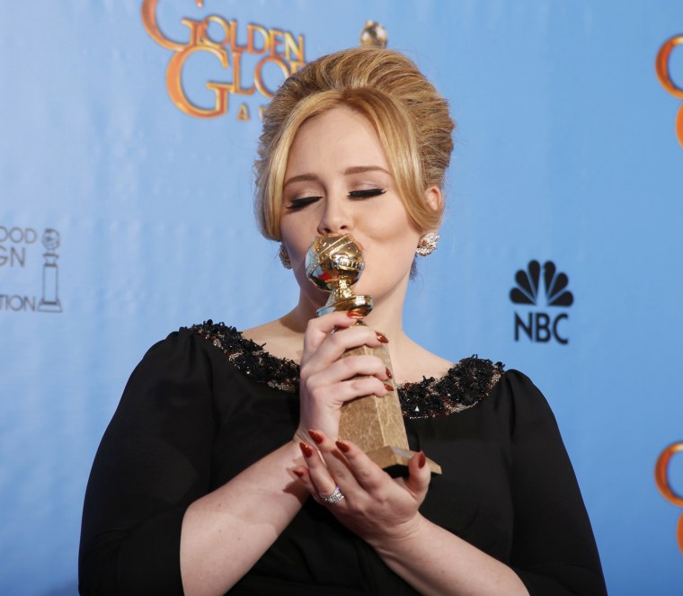 Image: Adele, winner for Best Original Song - Motion Picture, for \"Skyfall\" from the film of the same name, poses with her award backstage at the 70th annual Golden Globe Awards in Beverly Hills