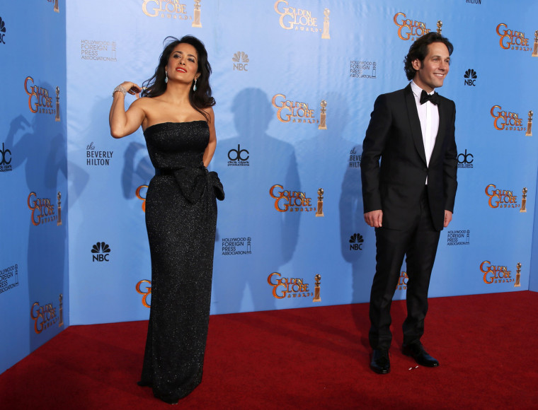Image: Presenters Salma Hayek and Paul Rudd pose backstage at the 70th annual Golden Globe Awards in Beverly Hills