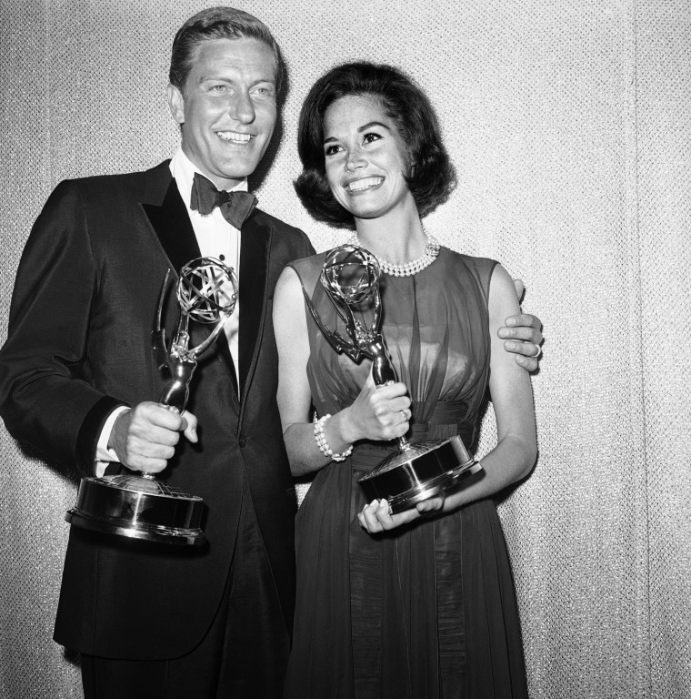 Dick Van Dyke, left, and Mary Tyler Moore co-stars of The Dick Van Dyke Show pose backstage at the Palladium with the Emmys won in the Television Academys 16th annual awards show, May 25, 1964, Los Angeles, Calif. They won the best actor and actress in a series with their Emmys. (AP Photo)