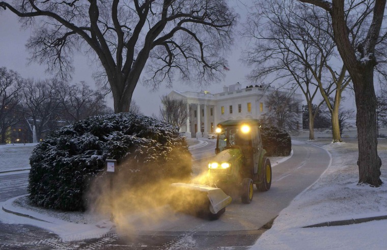 Image: The White House walkway is cleared of fresh snow which fell overnight in the Washington region
