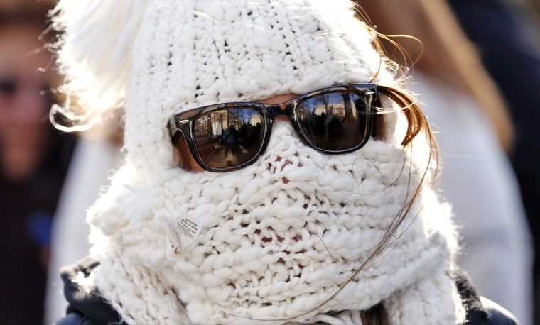 Image: Bundled up against extreme cold, Caruso of Akron, waits in a long line for tour of White House in Washington