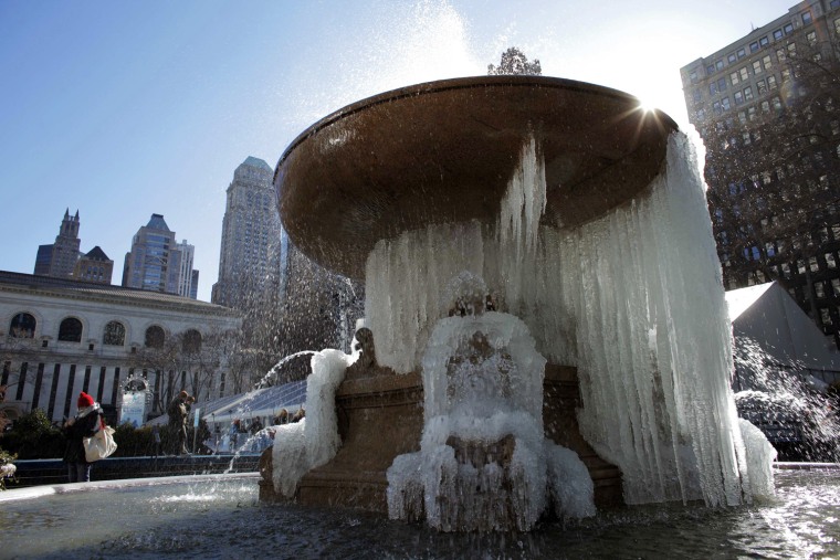 Image: A fountain partially covered by ice is seen at Bryant Park in New York