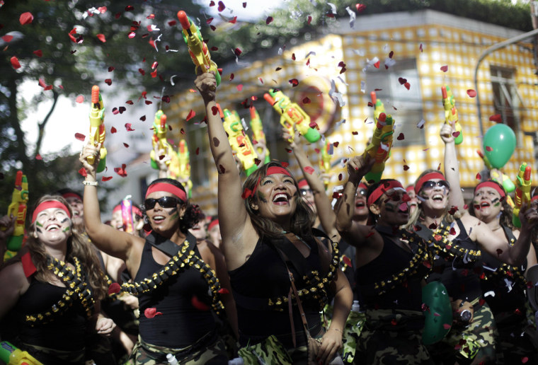Image: Revellers dance during the annual block party known as the \"Suvaco do Cristo\" (Armpit of Christ), one of the many pre-carnival parties to take place in the neighbourhoods of Rio de Janeiro